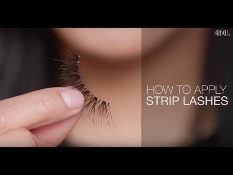 Video thumbnail showing how to apply strip lashes, featuring a close-up of a hand holding a false lash with tutorial text.