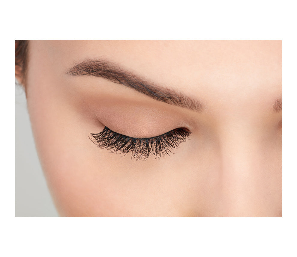 A model with a close right eye wearing Ardell Demi Wispies showing how it looks like when it's worn