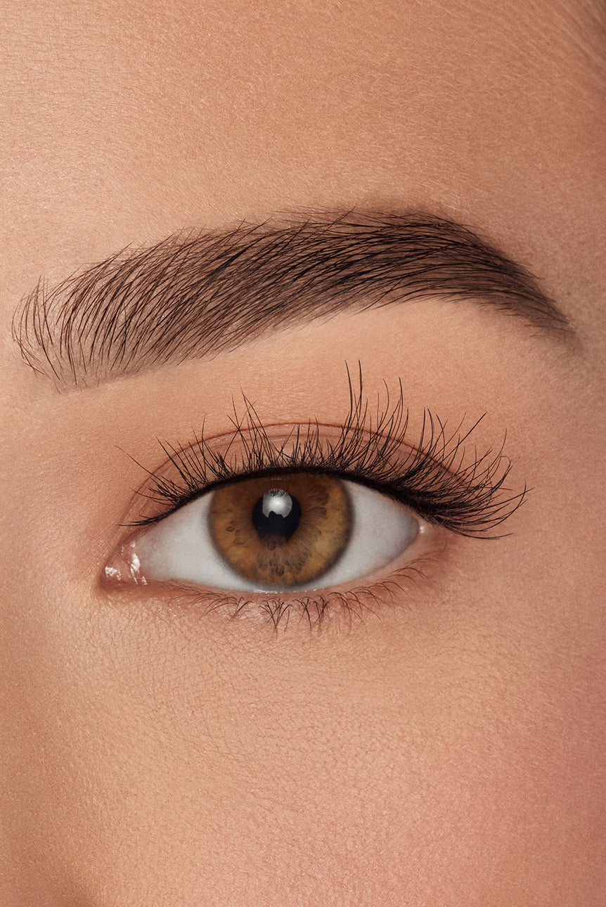 Close-up of eye with Ardell natural lashes applied, highlighting subtle volume and lifted curl.