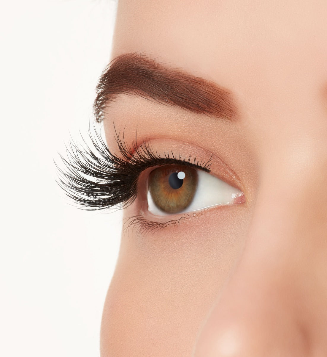 Side view close-up of a model's open right eye wearing Ardell Wispies 705 faux eye lashes