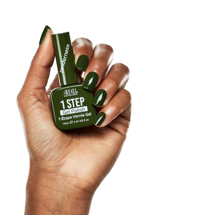 Model hand shot with Ardell Tenderness polish, showcasing a modern olive green nail color.