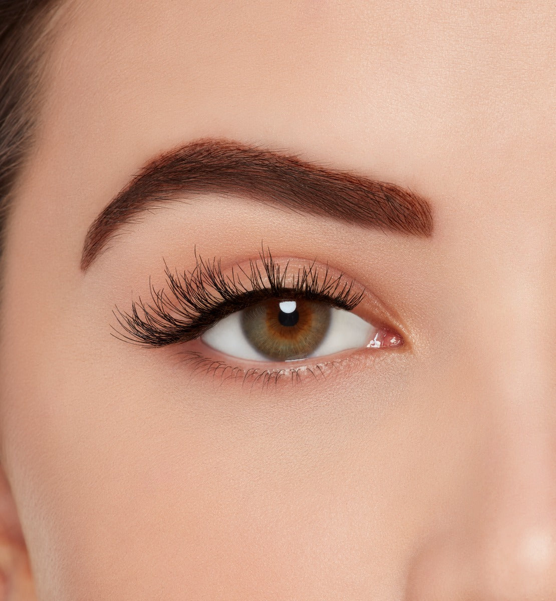 A model wearing Ardell Naked Lashes 425 featuring a whisper-light Wispies® layering and a short length for the natural look.