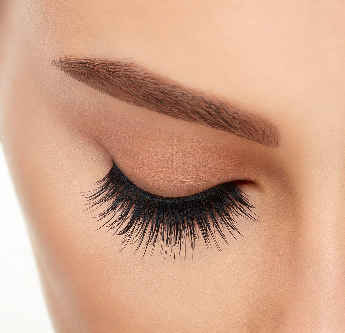 A model wearing Ardell's Double Up 207 with close right eye showing its extra-long layers with intense volume & fullness lash