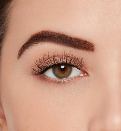A model wearing Ardell's Ecolashes 451 with open right eye showing its extra-long layers with medium volume & fullness lash