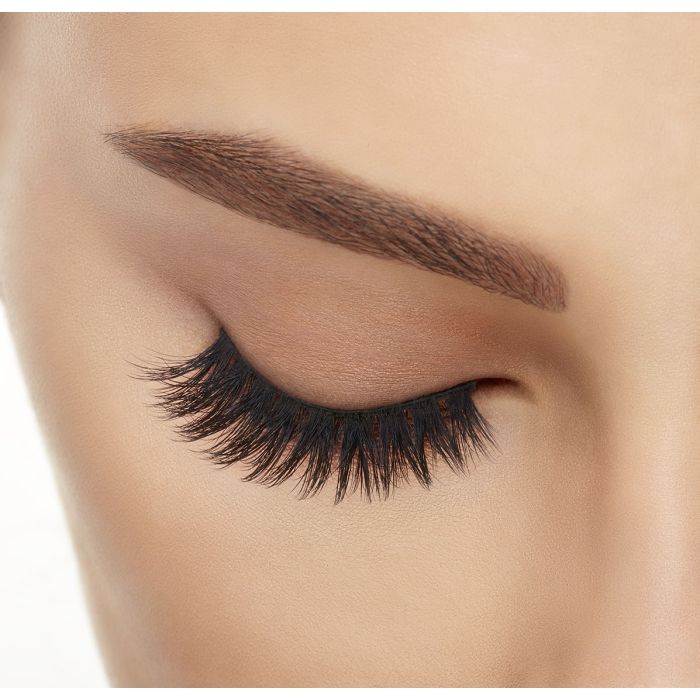 Eye with Ardell 860 lashes closed, showcasing full lash definition and fluffy finish.
