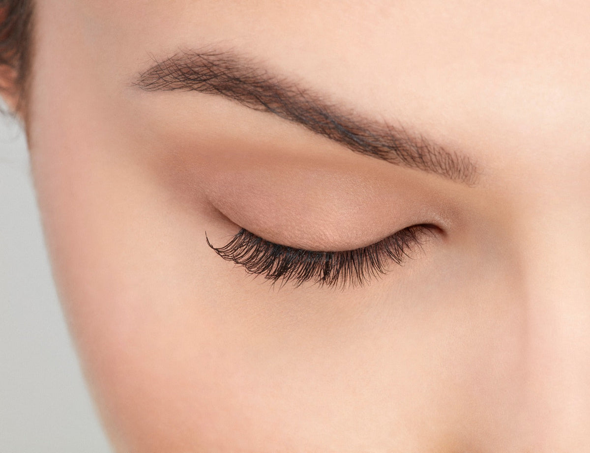Closer look of a model's closed right eye wearing an Ardell Lash Accent 301 false lash