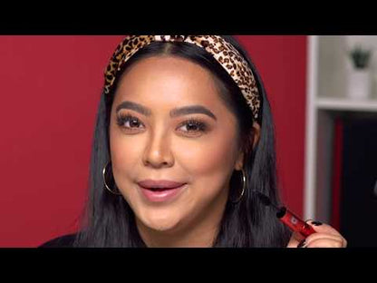 Model wearing leopard headband applies mascara with radiant glam makeup.